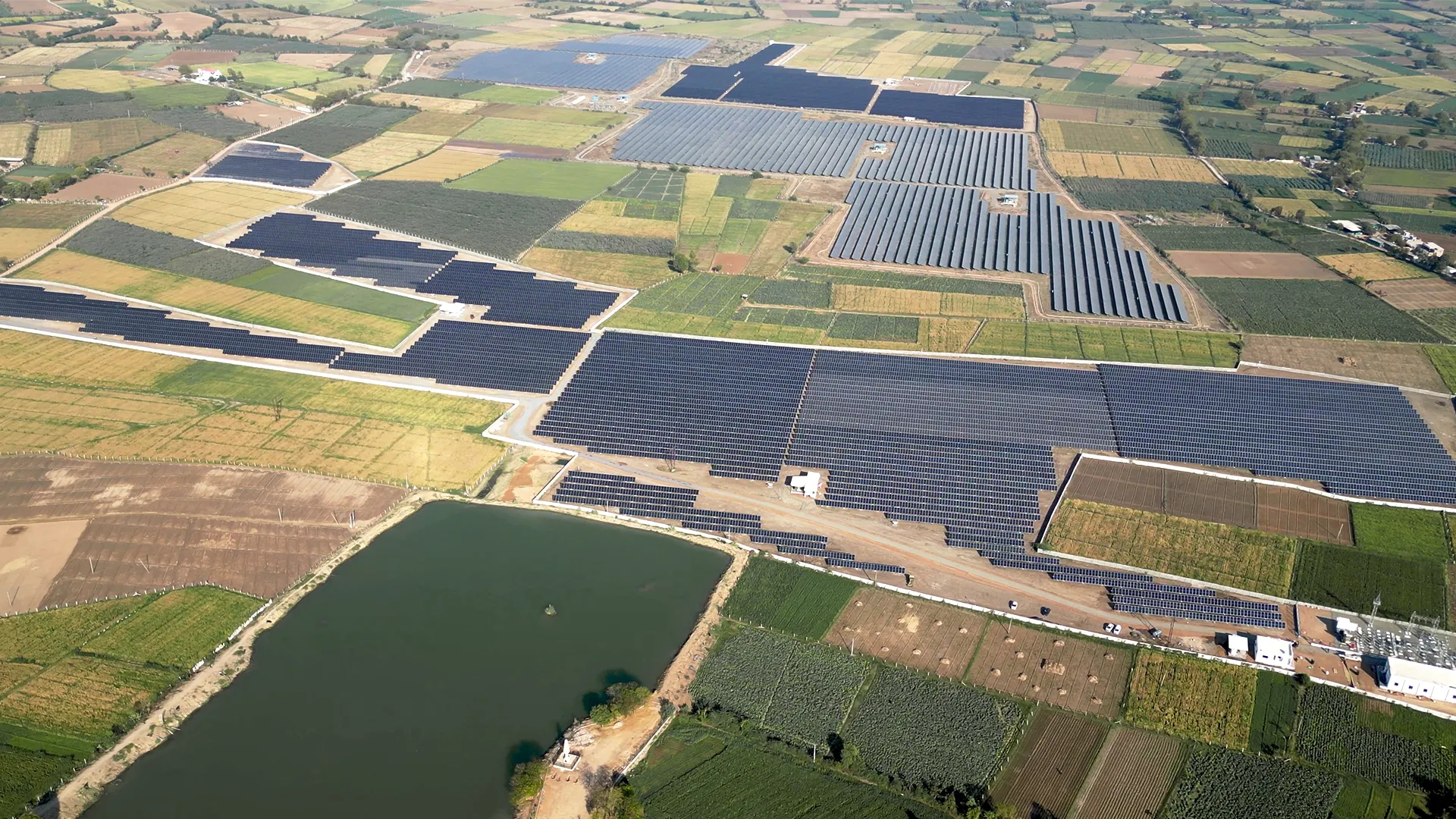 Wide-angle view of Rayzon Solar Park 7 in Shah showcasing a large solar power project.