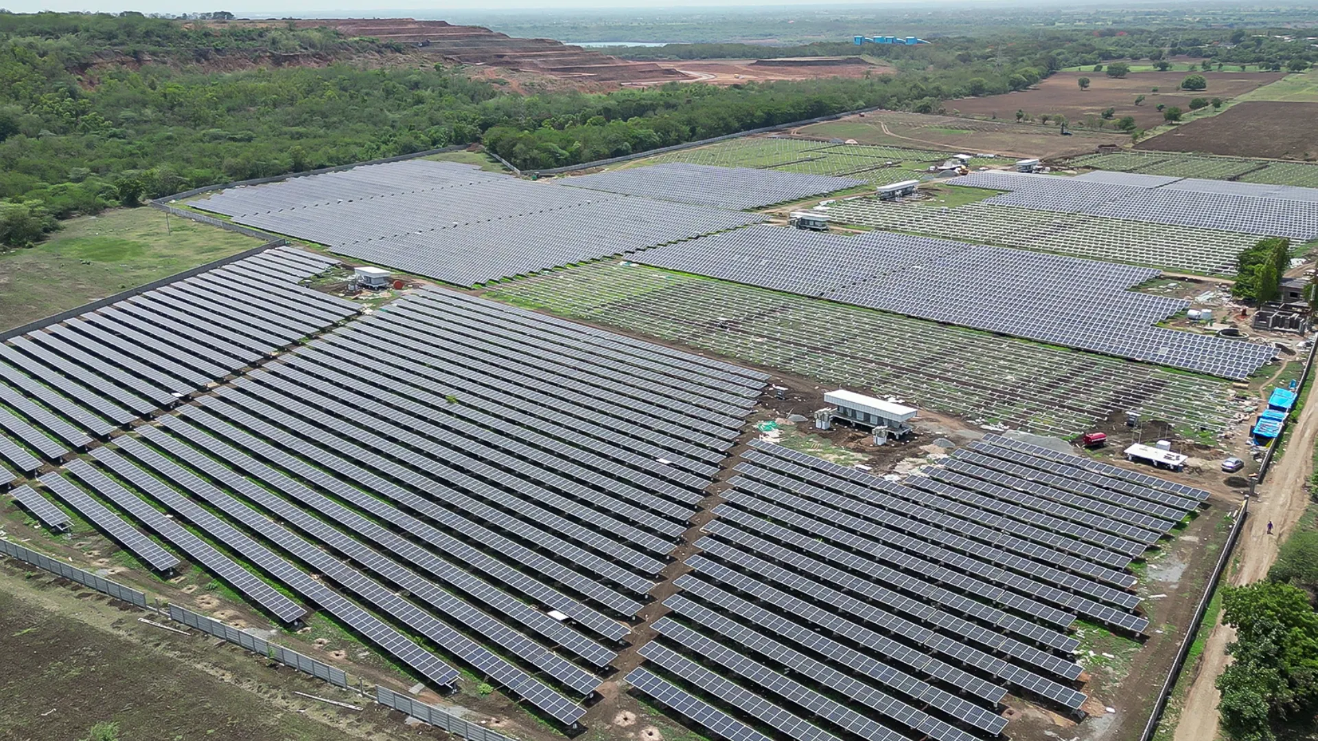 Aerial shot of Rayzon Solar Park 4 in Velachha with extensive ground-mounted solar panels.