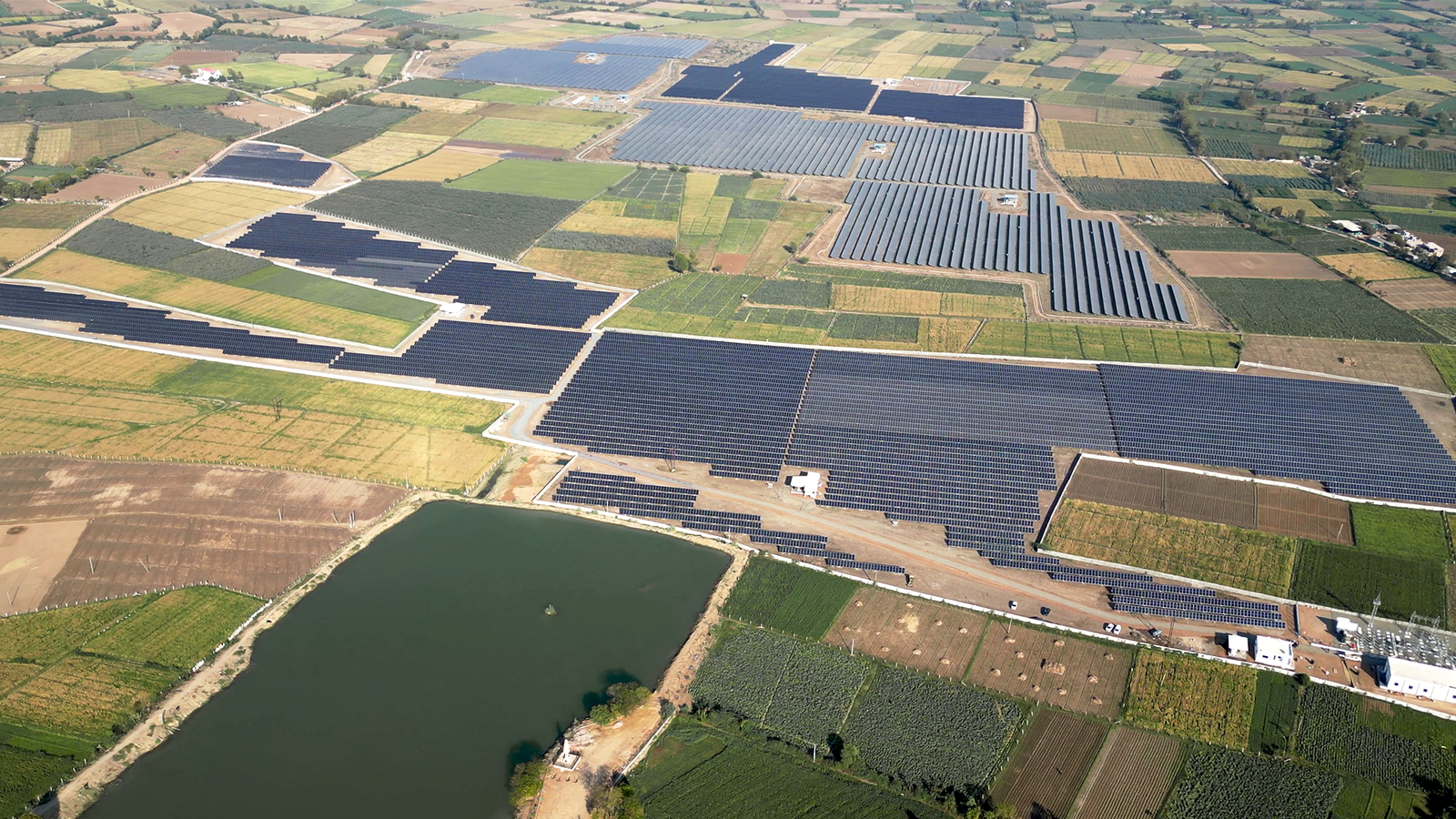 Wide-angle view of Rayzon Solar Park 7 in Shah showcasing a large solar power project.