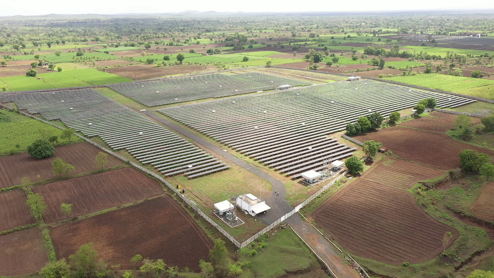 Large-scale solar installation at Rayzon Solar Park 5 in Umalla surrounded by farmland.