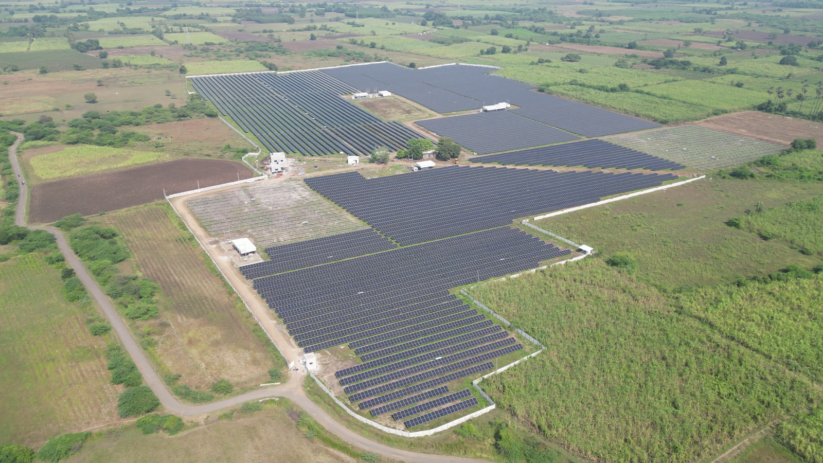 Aerial view of Rayzon Solar Park 9 in Ankolali with ground-mounted solar panels in rural landscapes.