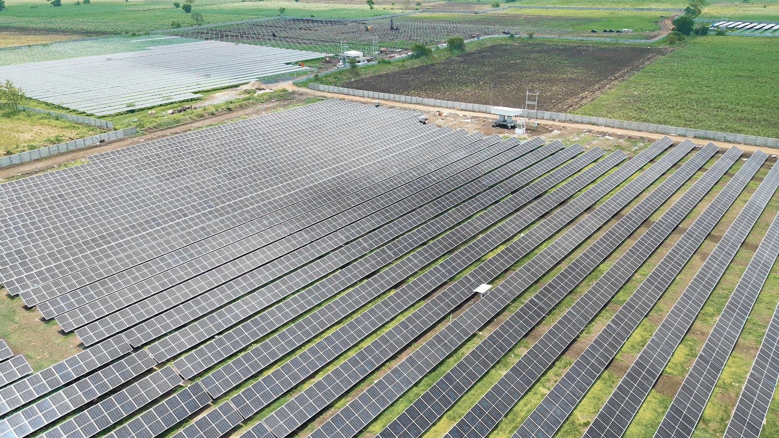 Aerial shot of Rayzon Solar Park 4 in Velachha with extensive ground-mounted solar panels.