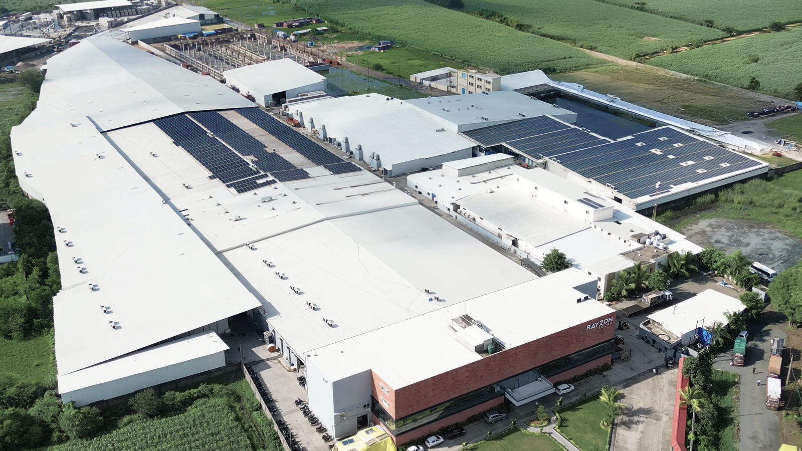 Aerial view of rooftop solar panels at Drishya Polyfills Pvt. Ltd industrial building.